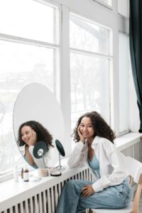 Person standing in front of a mirror reciting positive affirmations